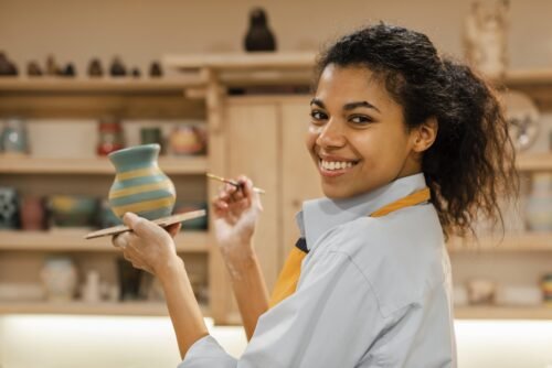 medium-shot-woman-painting-clay-pot